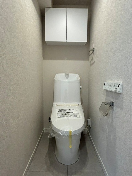 清潔感のあるトイレは、消耗品が収納できる吊戸棚付きで便利です。